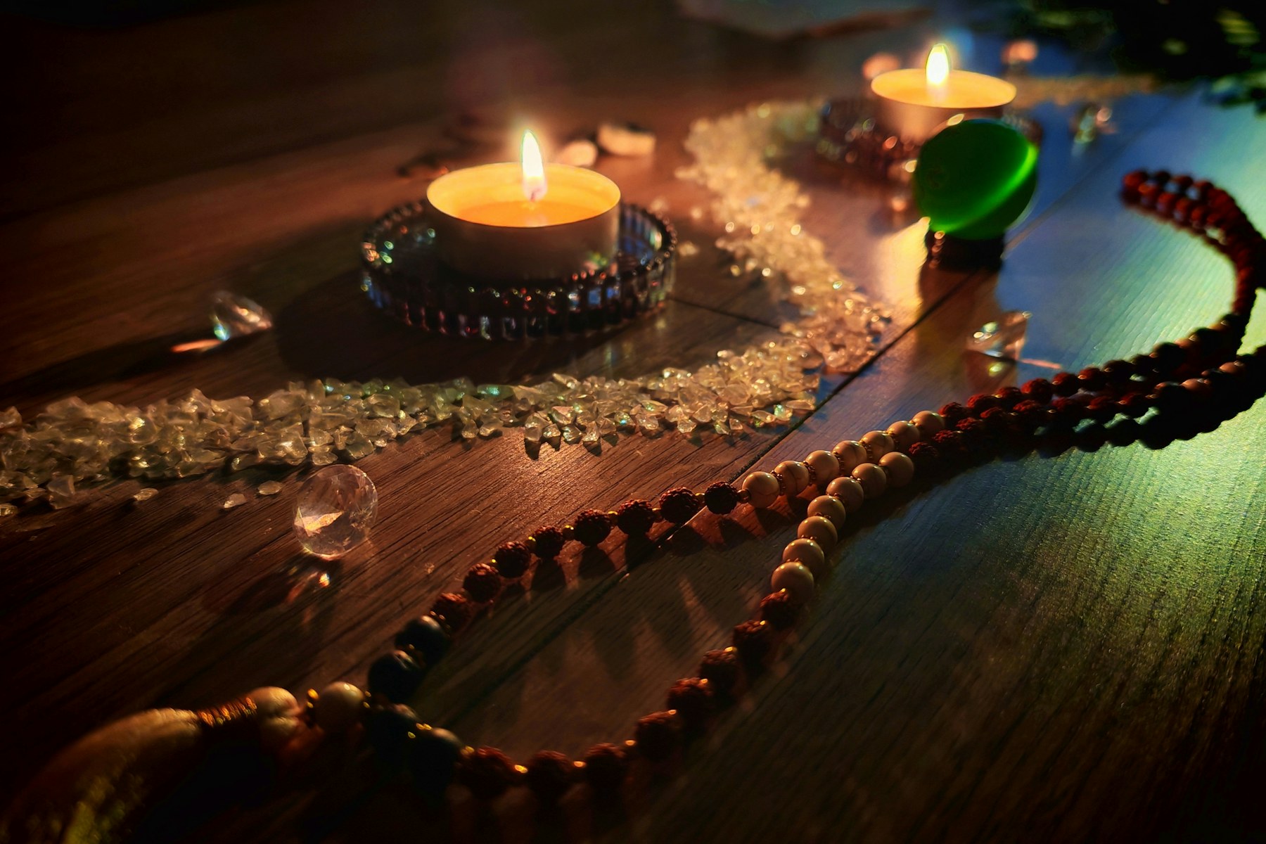 Clear crystals arranged in candlelight on a wooden table